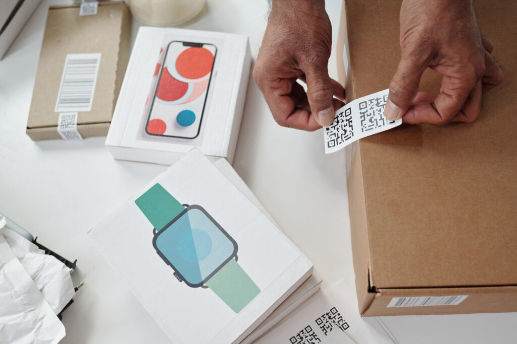 scanning qr code on shipping box in workspace