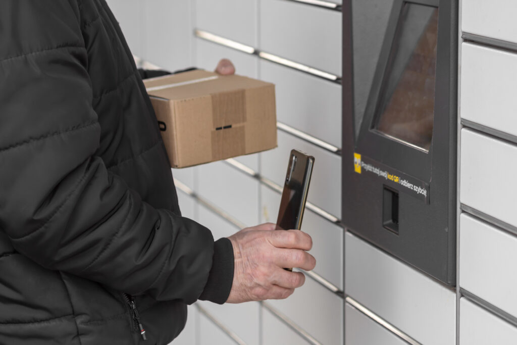 old man with smartphone entering qr code to open shopping locker. caption: read the qr code here and pick it up faster.