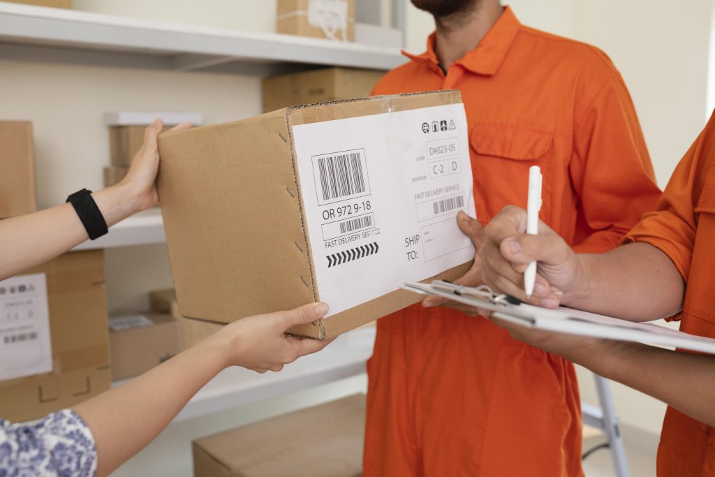 close up hands handing delivery boxes courier