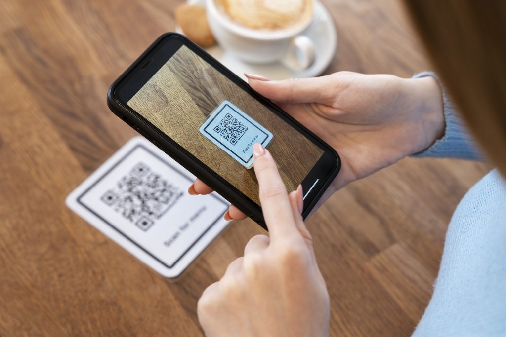 close up hands scanning qr code min