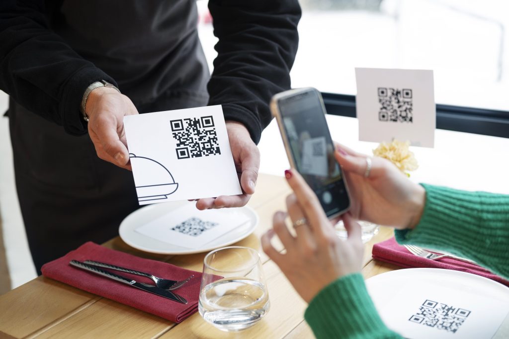 high angle hands scanning qr code min