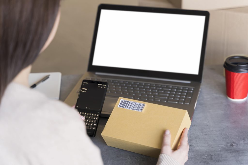 high angle woman looking up bar code box she s holding min