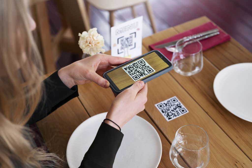 high angle woman scanning qr min